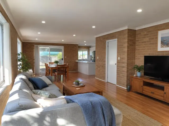 Living room and dining area with recessed LED downlights in a brick home interior in Valentine